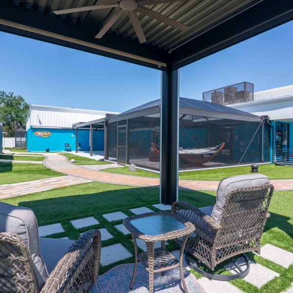 Freestanding Pergola X with lights and rolldown screens